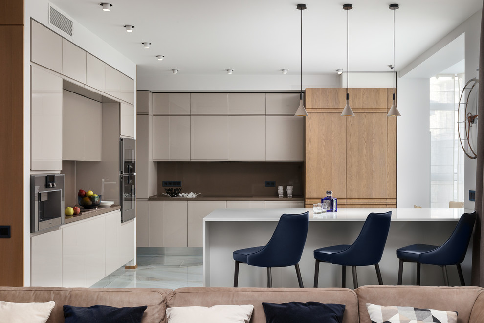 Contemporary open plan kitchen in Moscow with flat-panel cabinets, beige cabinets, brown splashback, a peninsula, white floor and brown benchtop.