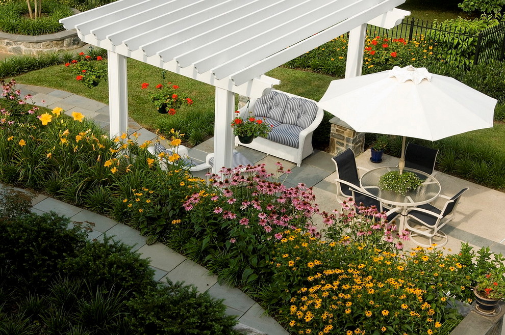 Large traditional backyard patio in DC Metro with natural stone pavers and a gazebo/cabana.