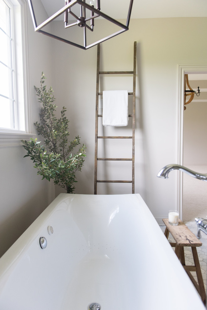 Example of a large transitional master white tile and subway tile marble floor and white floor freestanding bathtub design in Indianapolis with shaker cabinets, medium tone wood cabinets, a one-piece toilet, white walls, an undermount sink, marble countertops and a hinged shower door