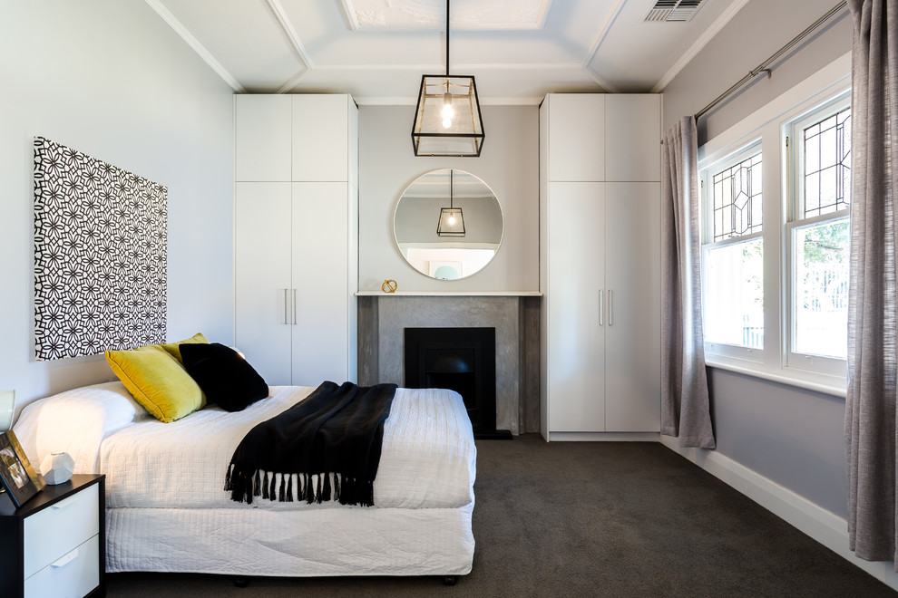 This is an example of a contemporary bedroom in Adelaide with grey walls, carpet, grey floor and a standard fireplace.