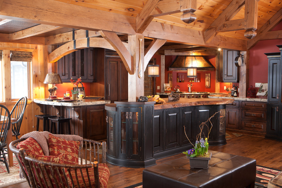 Eat-in kitchen - mid-sized rustic u-shaped medium tone wood floor eat-in kitchen idea in Toronto with raised-panel cabinets, distressed cabinets, granite countertops, paneled appliances and an island