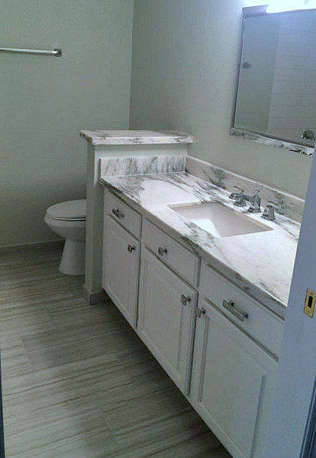 Inspiration for a mid-sized transitional bathroom in Phoenix with an undermount sink, raised-panel cabinets, white cabinets, marble benchtops, white tile, subway tile and porcelain floors.