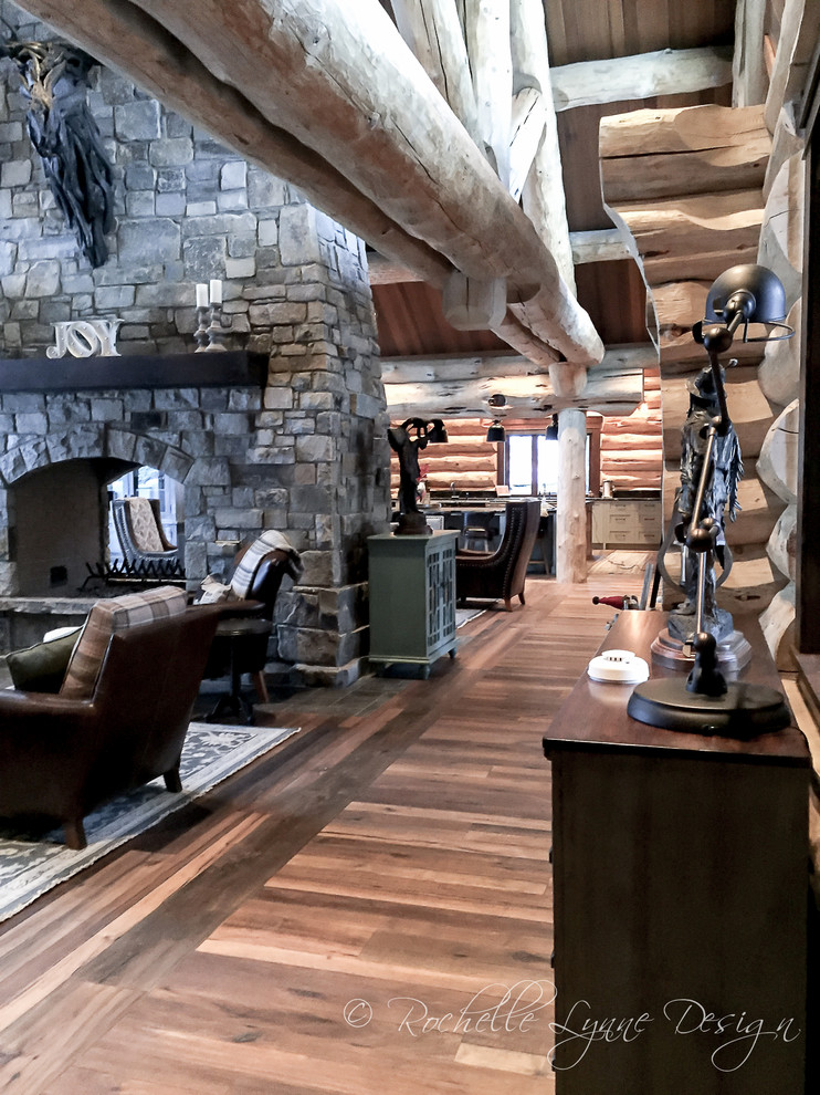 Example of a large mountain style medium tone wood floor hallway design in Calgary