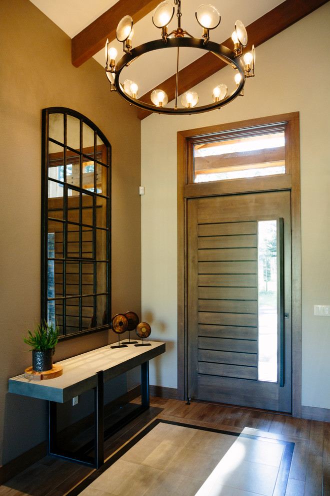 Inspiration for a large rustic medium tone wood floor front door remodel in Seattle with beige walls and a medium wood front door