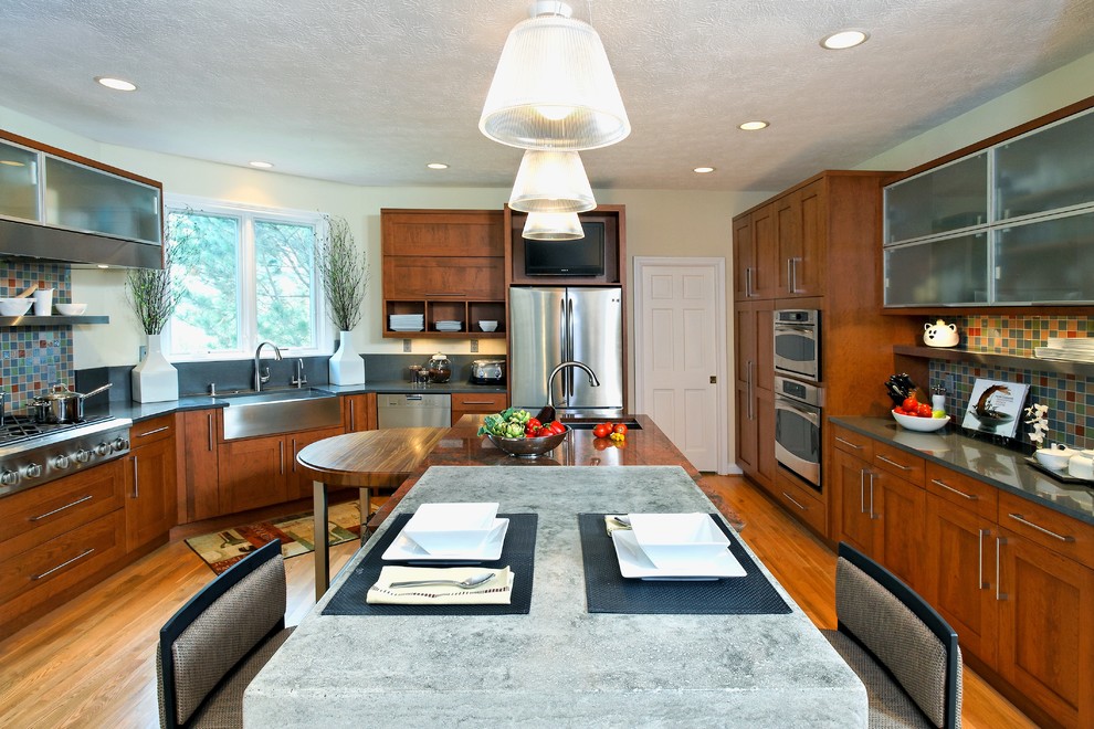Kitchen - transitional kitchen idea in Indianapolis with a drop-in sink, green cabinets, multicolored backsplash, stainless steel appliances and an island