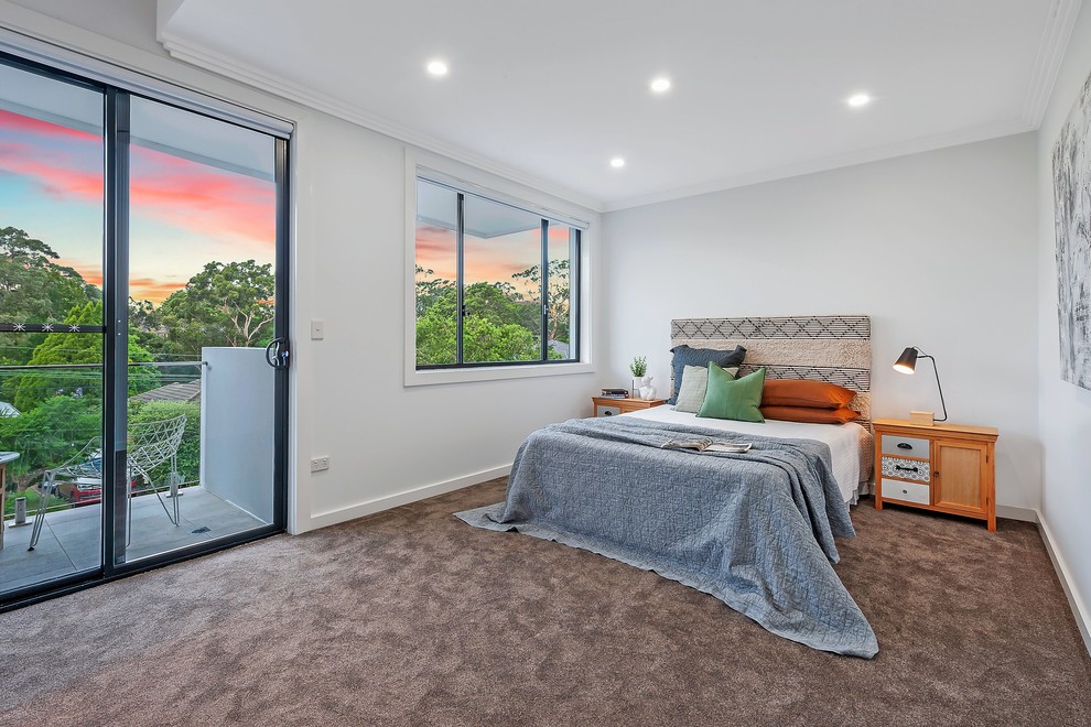 This is an example of a modern bedroom in Sydney with white walls, carpet and beige floor.