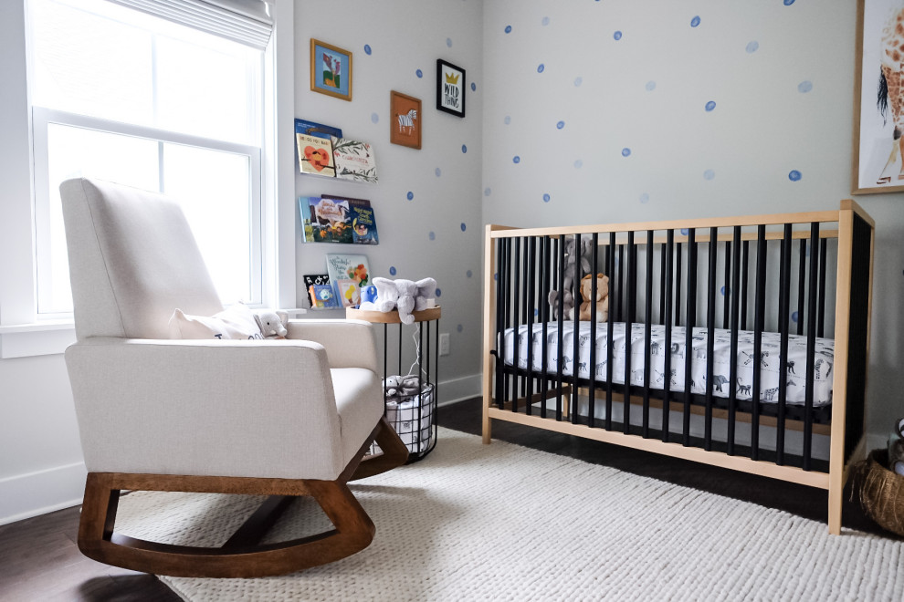 This is an example of a small modern nursery in Charleston with grey walls, dark hardwood floors, brown floor and wallpaper.