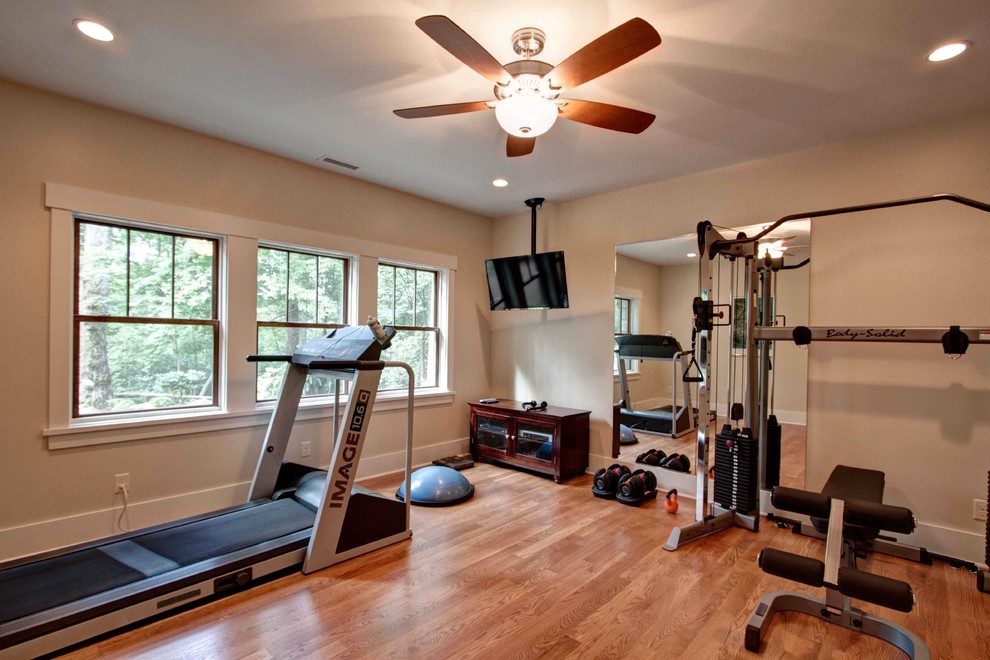Photo of a traditional multipurpose gym in Other with beige walls and light hardwood floors.