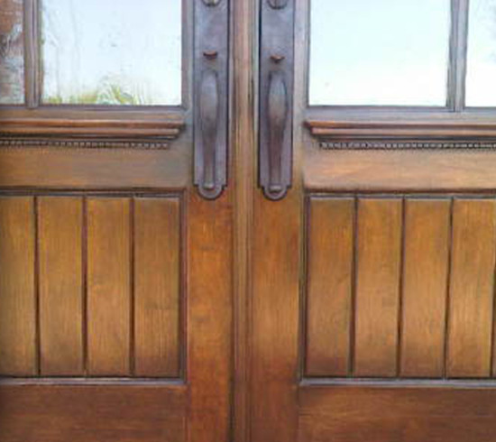 This is an example of an arts and crafts entryway in Portland with a double front door and a brown front door.