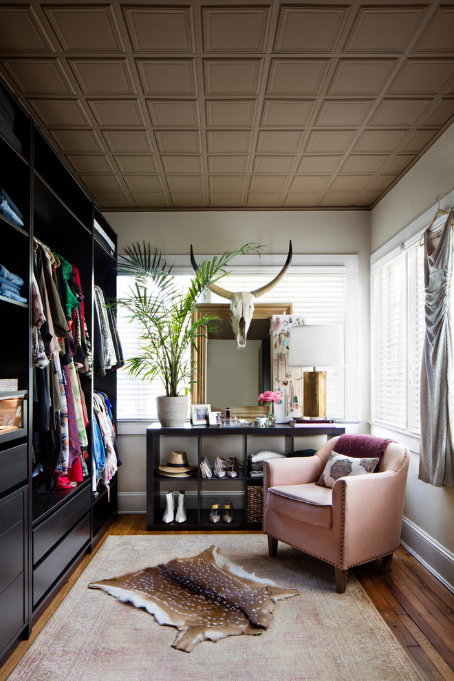 Photo of a transitional women's storage and wardrobe in Baltimore with flat-panel cabinets, dark wood cabinets, dark hardwood floors and brown floor.
