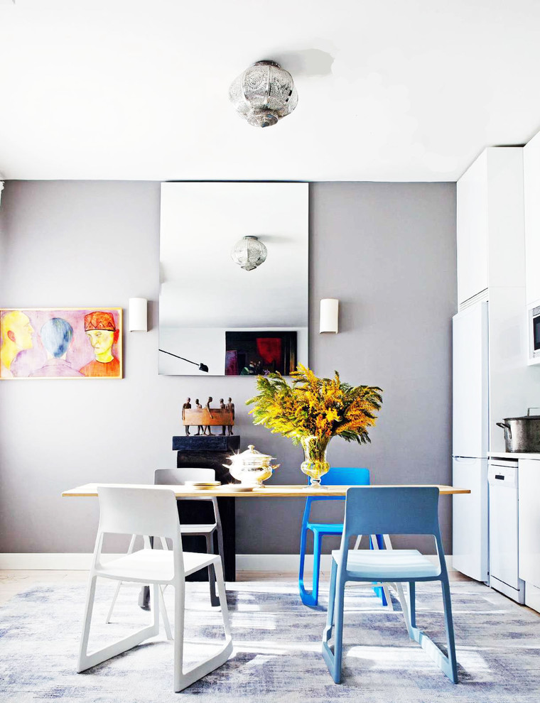 Design ideas for a mid-sized eclectic kitchen/dining combo in Madrid with grey walls and no fireplace.