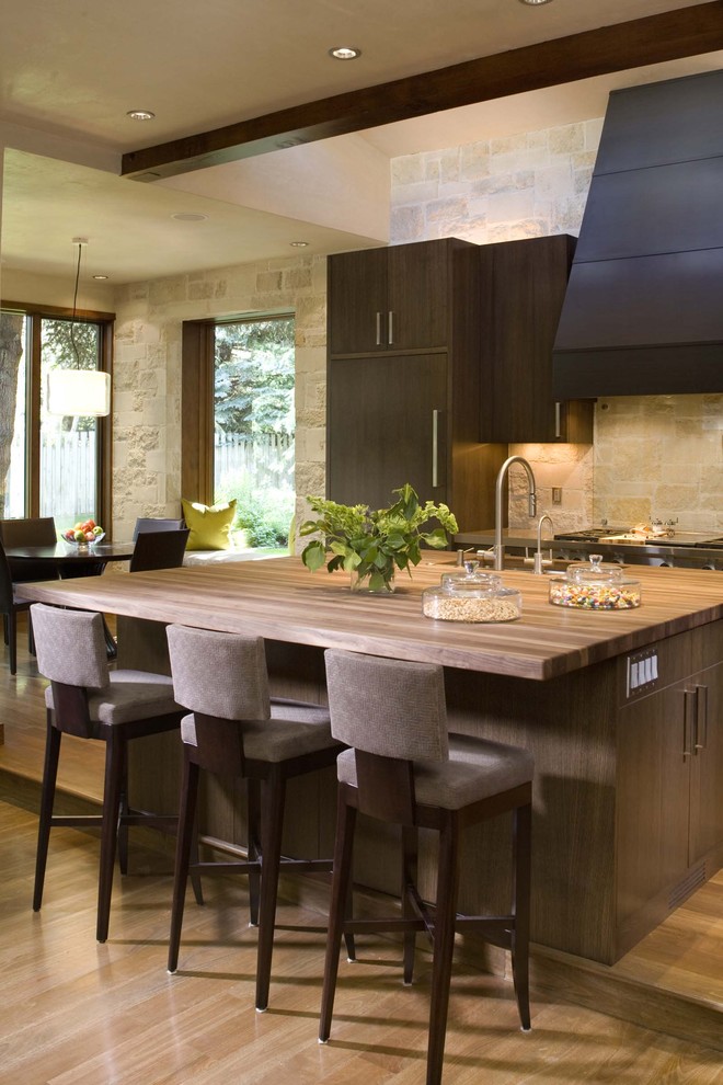 Country kitchen in Denver with wood benchtops and limestone splashback.