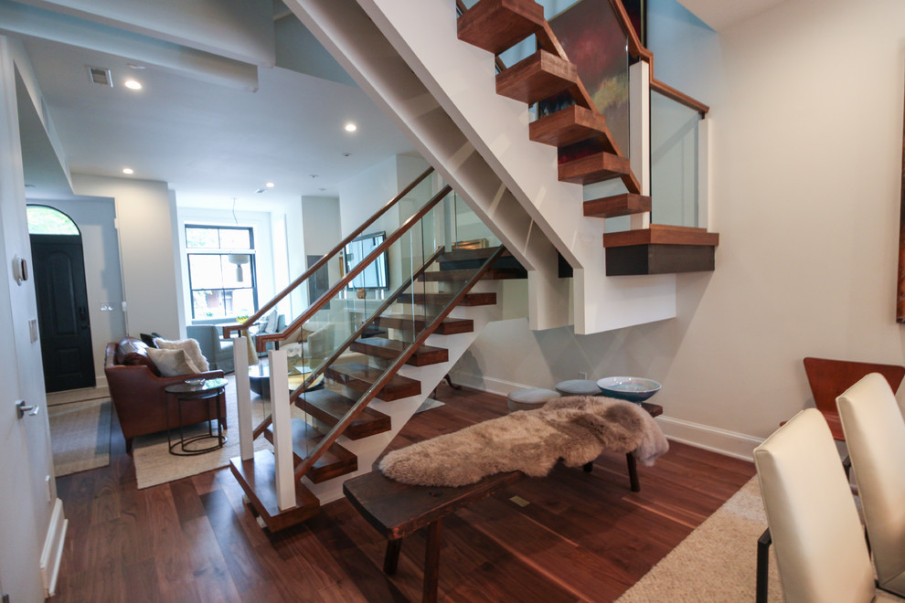 This is an example of an expansive contemporary glass floating staircase in DC Metro with open risers and glass railing.