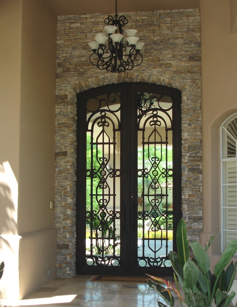 Photo of a mid-sized traditional entryway in Phoenix with beige walls, a double front door and a brown front door.
