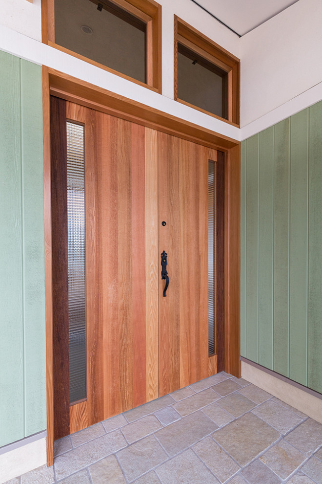 Photo of a small contemporary foyer in Other with green walls, marble floors, a double front door, a medium wood front door, beige floor and wood walls.