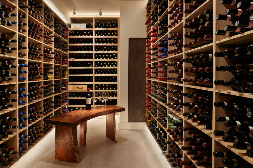 Mid-sized midcentury wine cellar in Seattle with porcelain floors, display racks and grey floor.