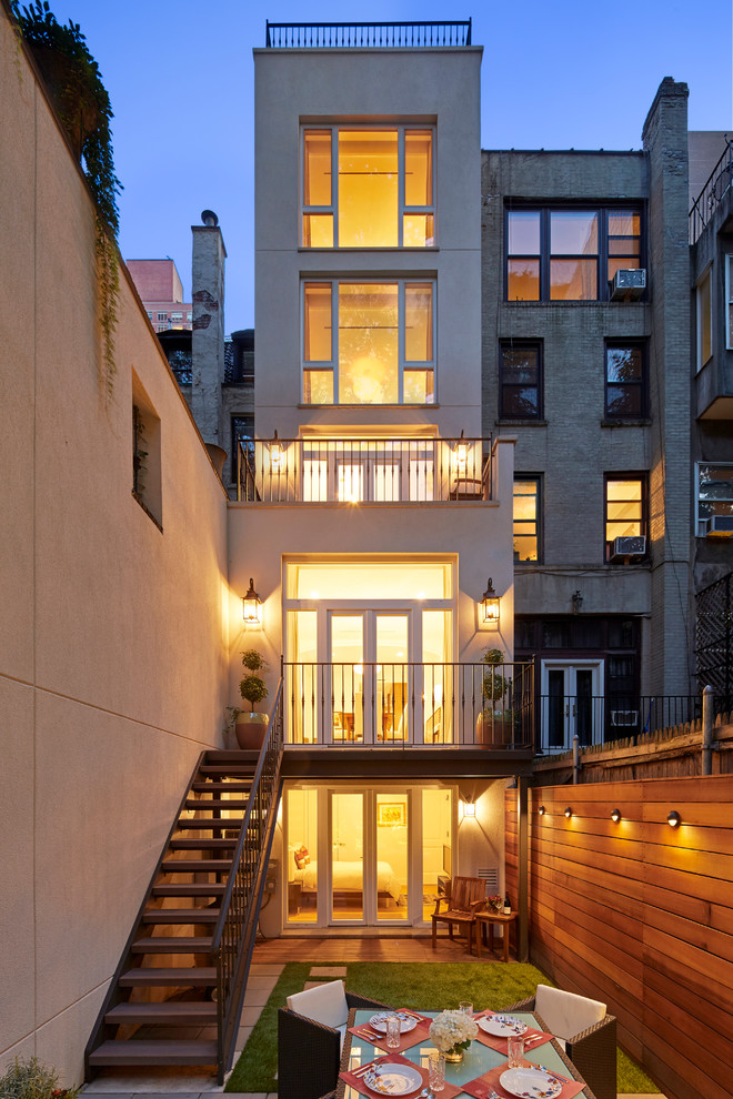 Inspiration for a transitional white exterior in New York with a flat roof.