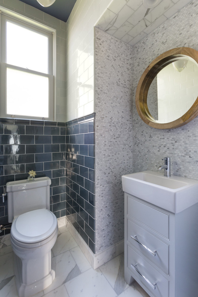 Inspiration for a small traditional cloakroom in San Francisco with raised-panel cabinets, grey cabinets, multi-coloured tiles, ceramic tiles, multi-coloured walls, marble flooring, grey worktops, a drop ceiling, wainscoting, a two-piece toilet, a pedestal sink, quartz worktops, a freestanding vanity unit and white floors.