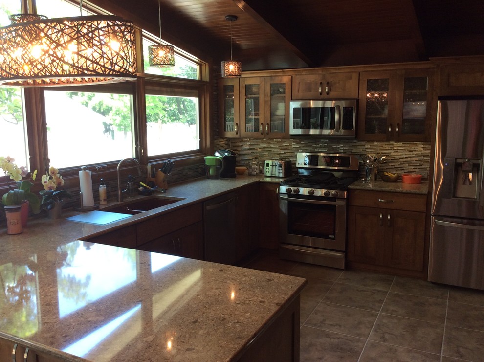Eat-in kitchen - rustic porcelain tile eat-in kitchen idea in Chicago with shaker cabinets, medium tone wood cabinets, quartz countertops, multicolored backsplash, mosaic tile backsplash, stainless steel appliances, a peninsula and an undermount sink