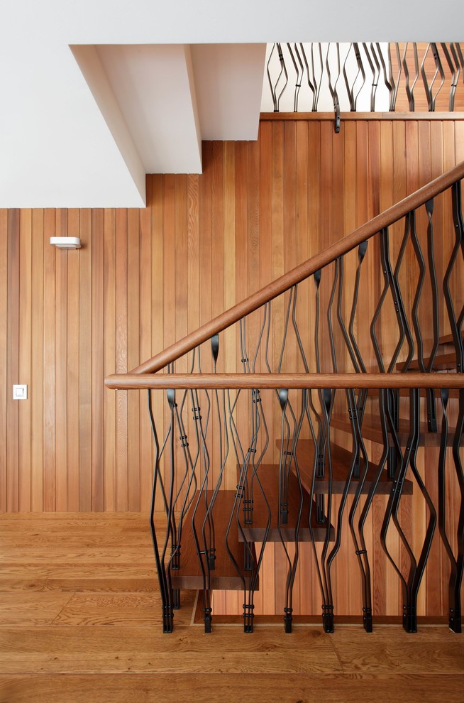 Contemporary wood u-shaped staircase in Moscow with wood risers.