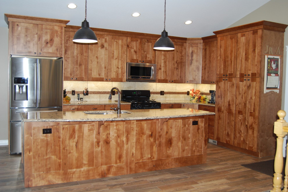 Inspiration for a mid-sized rustic l-shaped porcelain tile and brown floor eat-in kitchen remodel with an undermount sink, beaded inset cabinets, medium tone wood cabinets, beige backsplash, porcelain backsplash, an island, quartz countertops and stainless steel appliances