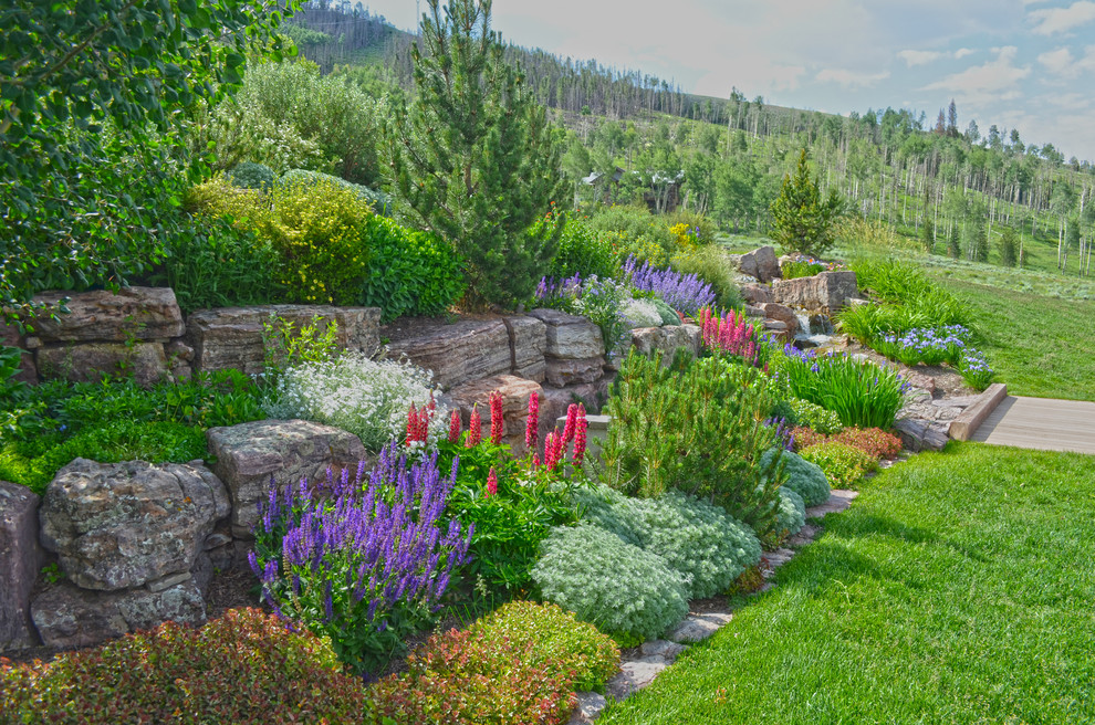 Inspiration for a rustic full sun backyard retaining wall landscape in Other for summer.