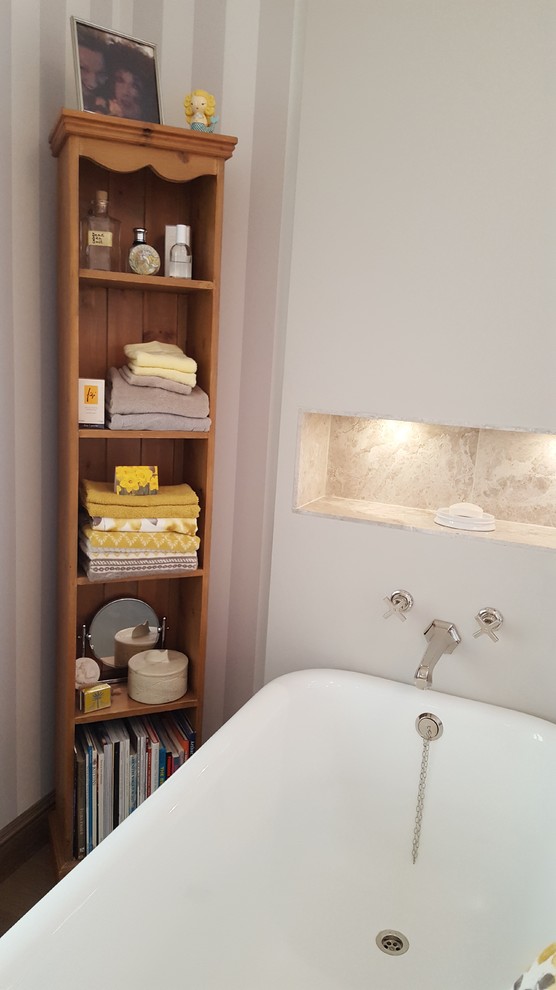 Inspiration for a large traditional family bathroom in Other with freestanding cabinets, a freestanding bath, an alcove shower, a wall mounted toilet, grey tiles, stone tiles, grey walls, medium hardwood flooring, a pedestal sink, marble worktops, brown floors and a hinged door.