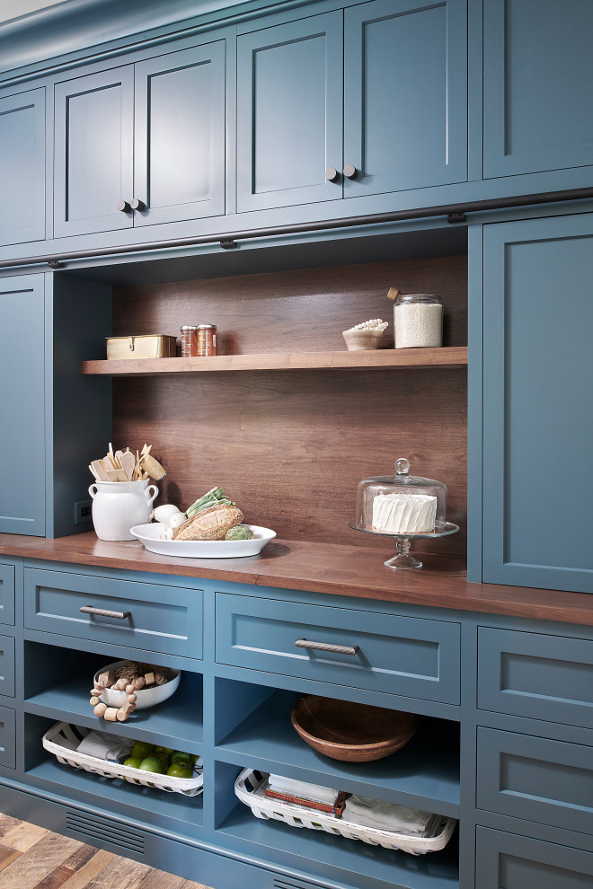Inspiration for a mid-sized medium tone wood floor and brown floor kitchen pantry remodel in Philadelphia with an undermount sink, recessed-panel cabinets, blue cabinets, quartzite countertops, paneled appliances, an island and blue countertops