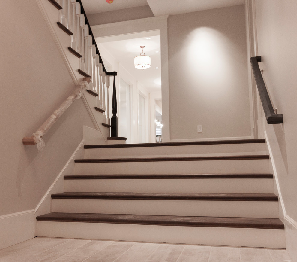Design ideas for a large traditional wood straight staircase in DC Metro with wood risers and wood railing.