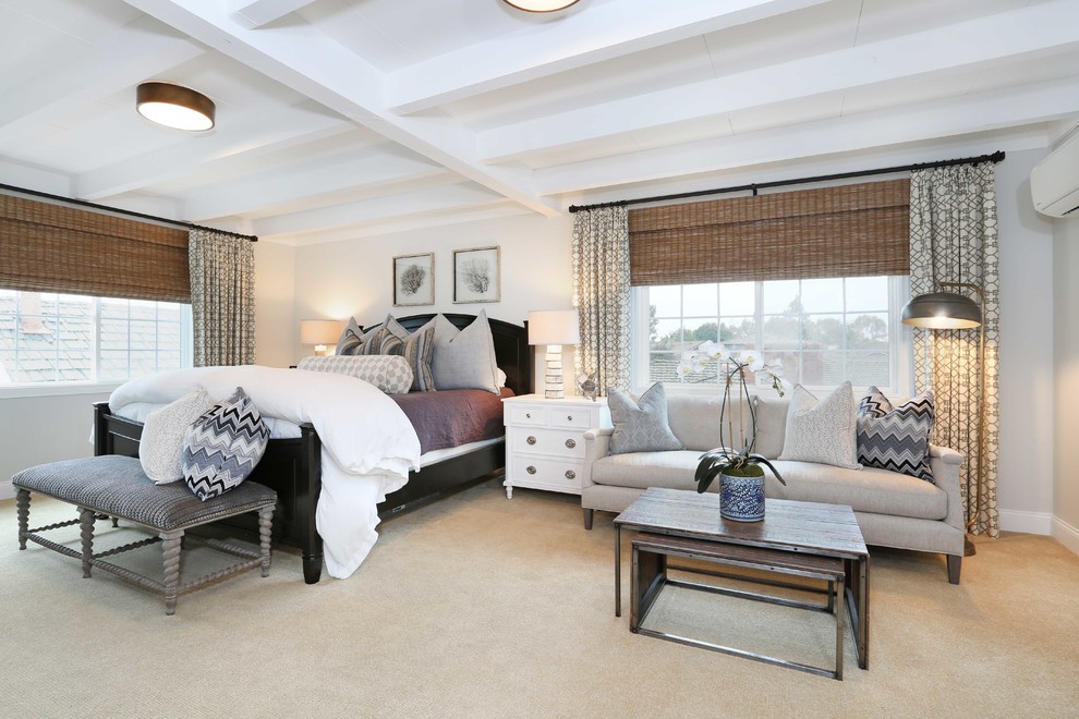 This is an example of an eclectic master bedroom in Orange County with carpet.