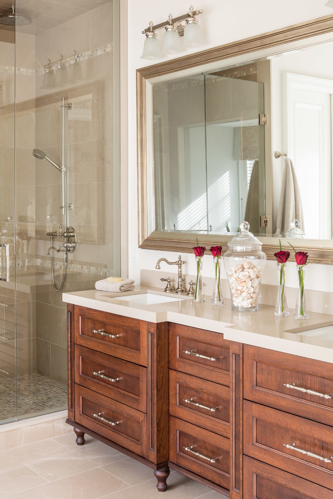Inspiration for a large traditional master bathroom in Toronto with an undermount sink, recessed-panel cabinets, medium wood cabinets, engineered quartz benchtops, an alcove shower, beige tile, ceramic tile, white walls and ceramic floors.