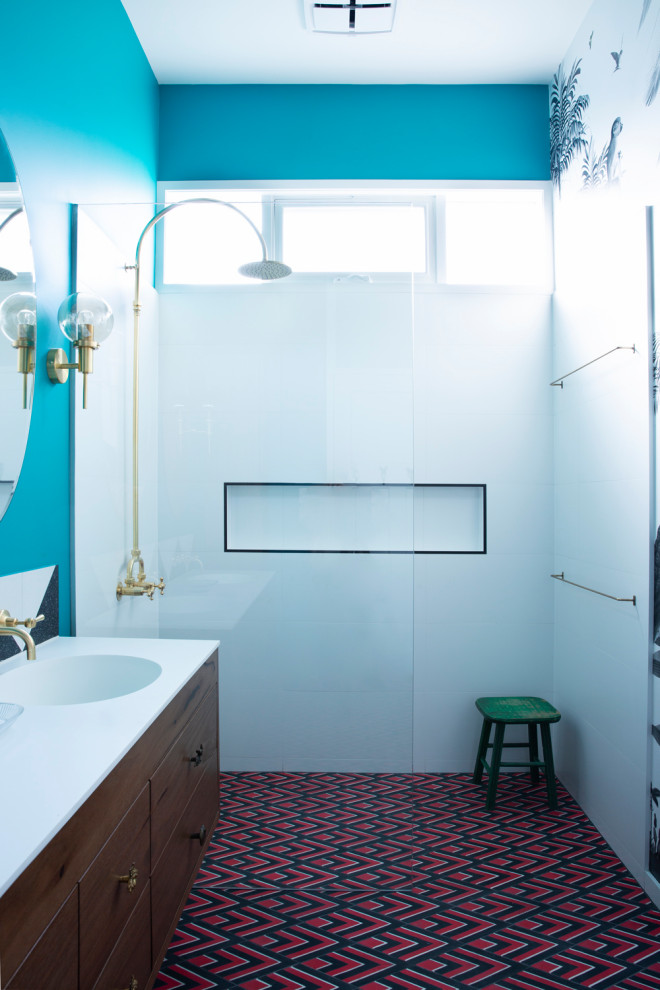 Design ideas for a mid-sized eclectic kids bathroom in Melbourne with black cabinets, a corner shower, a wall-mount toilet, white tile, ceramic tile, blue walls, ceramic floors, an integrated sink, multi-coloured floor, an open shower, white benchtops, a double vanity, a floating vanity and wallpaper.