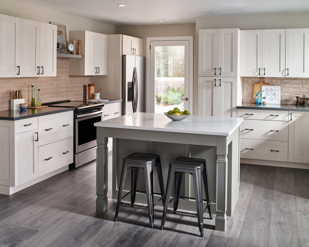 Inspiration for a large transitional u-shaped kitchen in New York with dark hardwood floors, brown floor, an undermount sink, quartzite benchtops, beige splashback, stainless steel appliances, with island, shaker cabinets, light wood cabinets and grey benchtop.