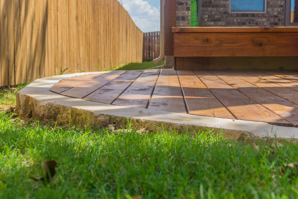 Mid-sized mountain style backyard deck photo in Austin with a roof extension