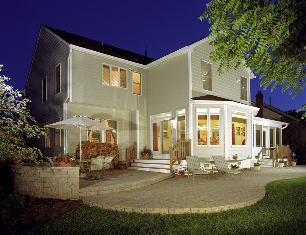 Design ideas for a traditional two-storey exterior in DC Metro with wood siding.