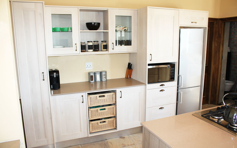 Mid-sized mountain style open concept kitchen photo with a double-bowl sink, shaker cabinets, light wood cabinets, granite countertops, stainless steel appliances and an island