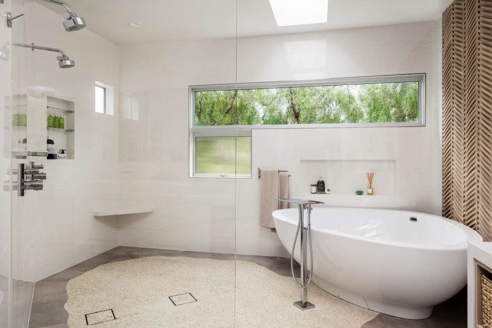 Photo of a small contemporary master wet room bathroom in Orange County with flat-panel cabinets, light wood cabinets, a freestanding tub, a one-piece toilet, porcelain tile, white walls, porcelain floors, a trough sink, engineered quartz benchtops, grey floor, an open shower, white benchtops and white tile.