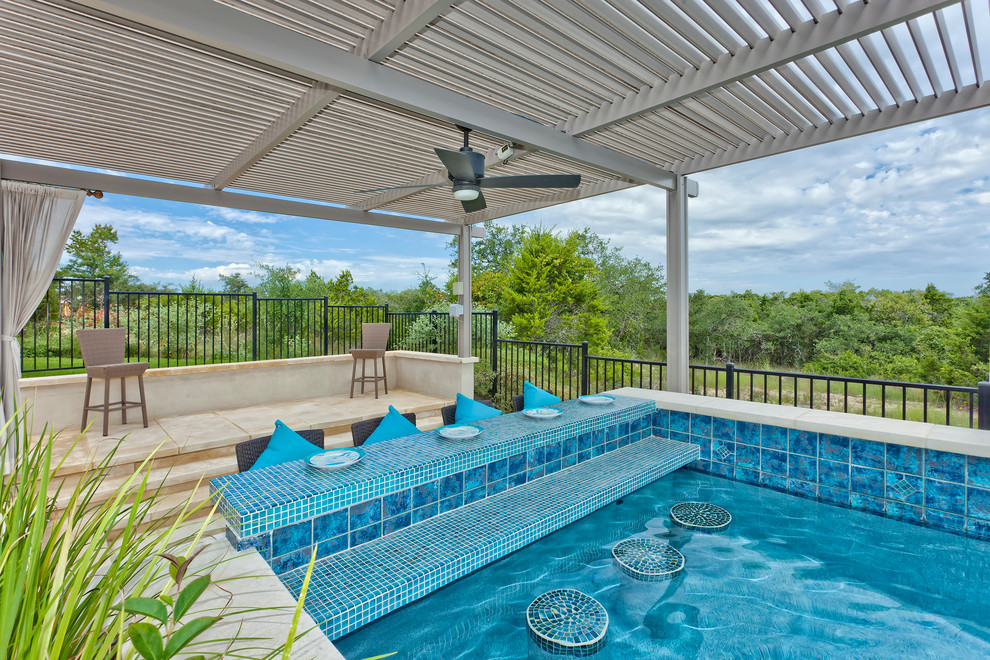 This is an example of a mid-sized modern backyard custom-shaped lap pool in Austin with a hot tub and tile.