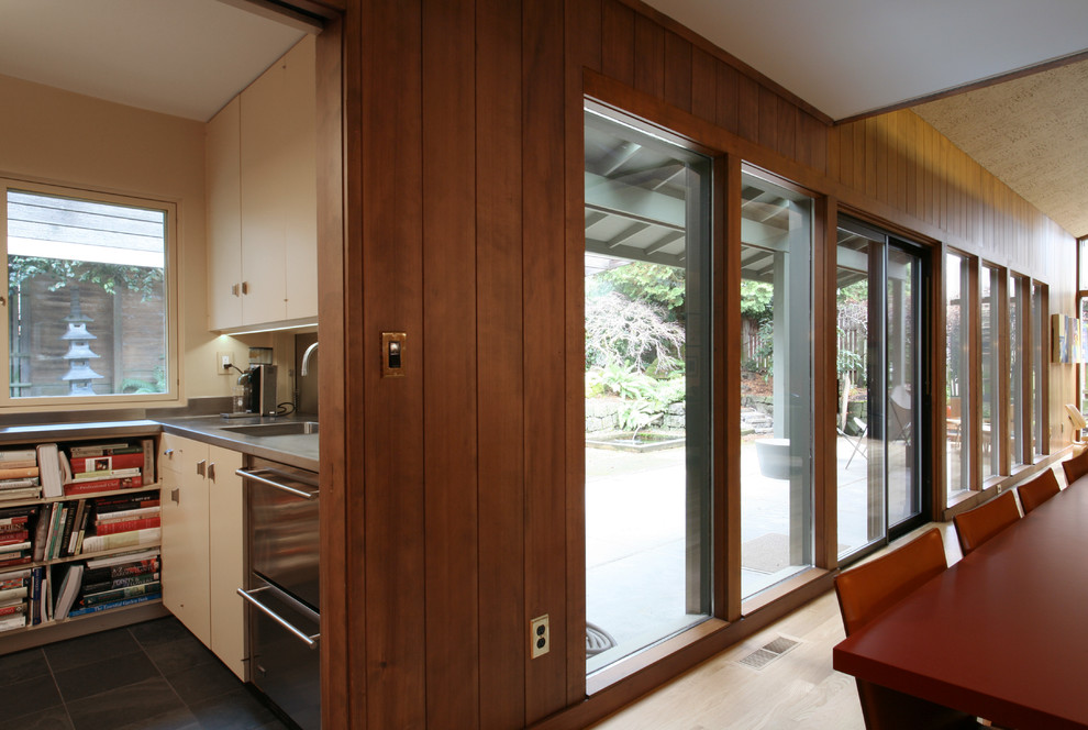 This is an example of a midcentury dining room in Portland.