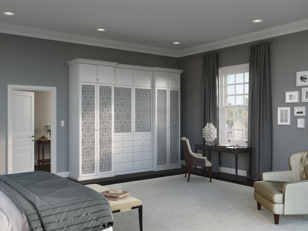 Inspiration for a large traditional women's built-in wardrobe in Nashville with flat-panel cabinets, white cabinets and dark hardwood floors.