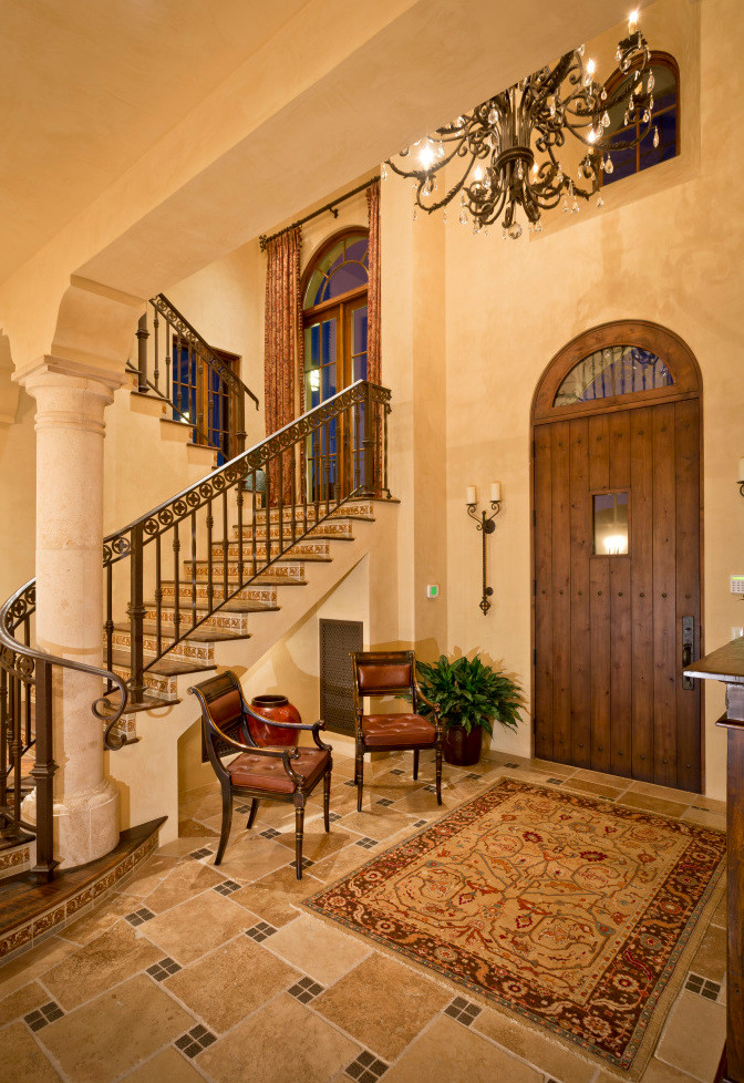 Photo of an expansive tile curved staircase in Phoenix with wood risers.