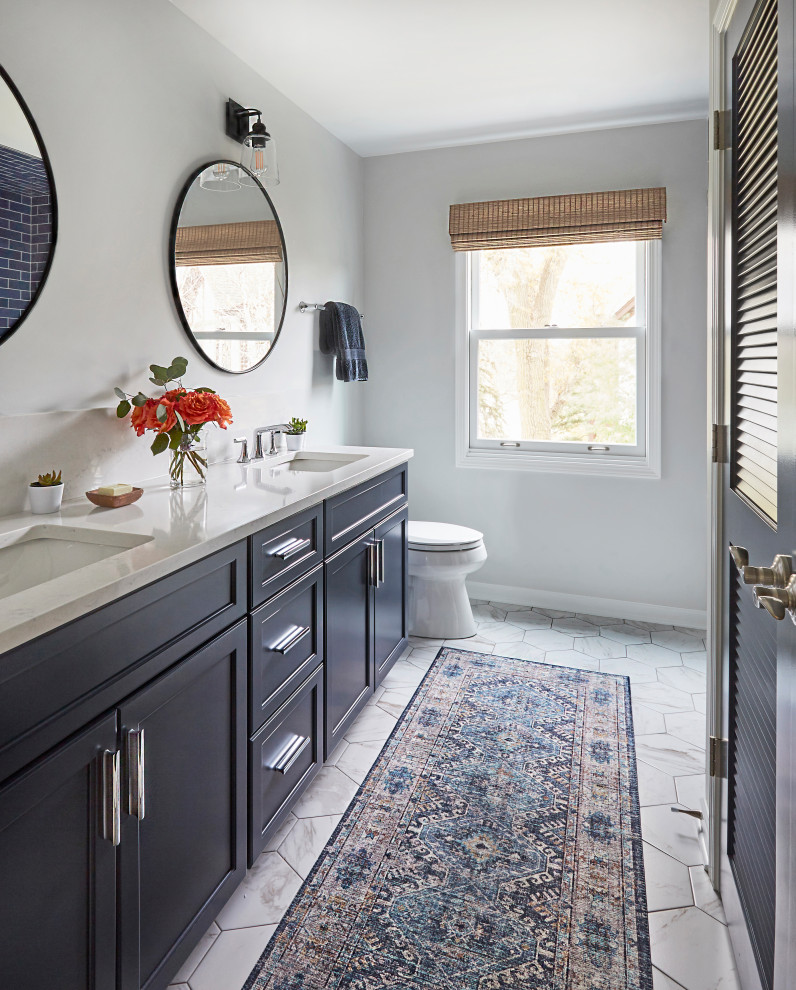 Exempel på ett mellanstort klassiskt vit vitt badrum med dusch, med luckor med infälld panel, blå skåp, ett badkar i en alkov, en dusch/badkar-kombination, en toalettstol med hel cisternkåpa, blå kakel, tunnelbanekakel, grå väggar, mosaikgolv, ett undermonterad handfat, bänkskiva i kvartsit, vitt golv och dusch med duschdraperi