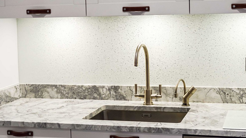 Photo of a modern kitchen in Hertfordshire with white splashback and glass sheet splashback.