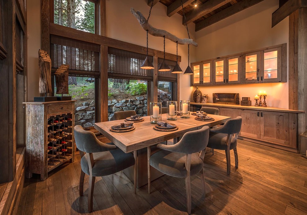 This is an example of a country dining room in Sacramento with beige walls and dark hardwood floors.