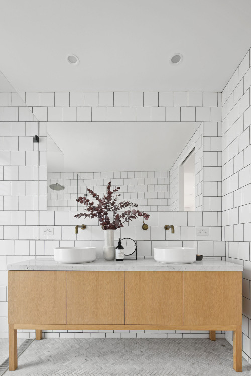 Timeless Elegance with White Subway Tiles and a Frameless Mirror