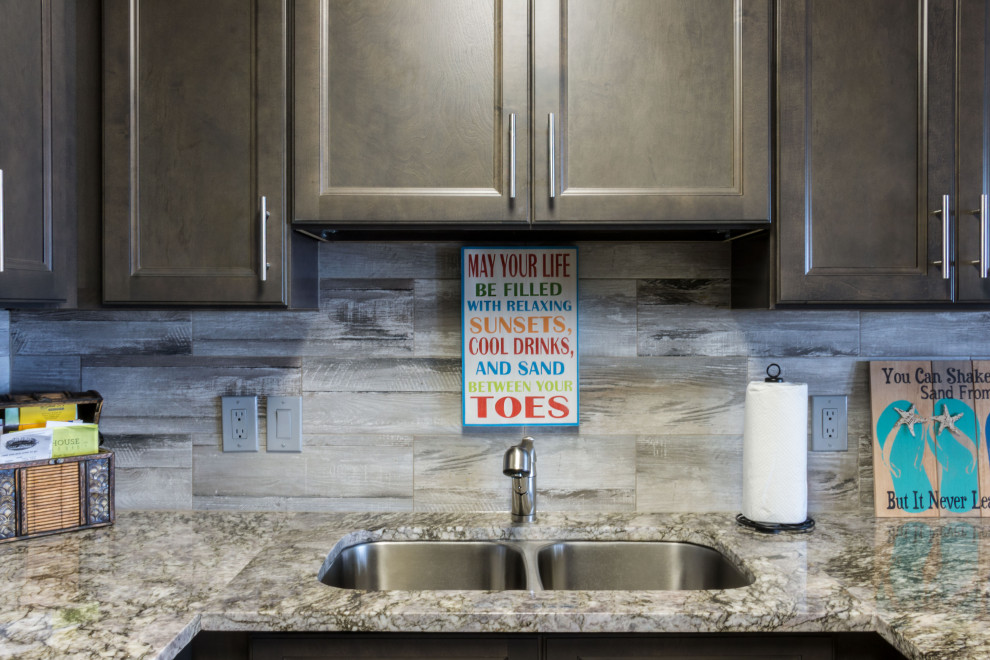 Small mountain style u-shaped cement tile floor and beige floor eat-in kitchen photo with an undermount sink, flat-panel cabinets, medium tone wood cabinets, granite countertops, gray backsplash, ceramic backsplash, stainless steel appliances, a peninsula and gray countertops