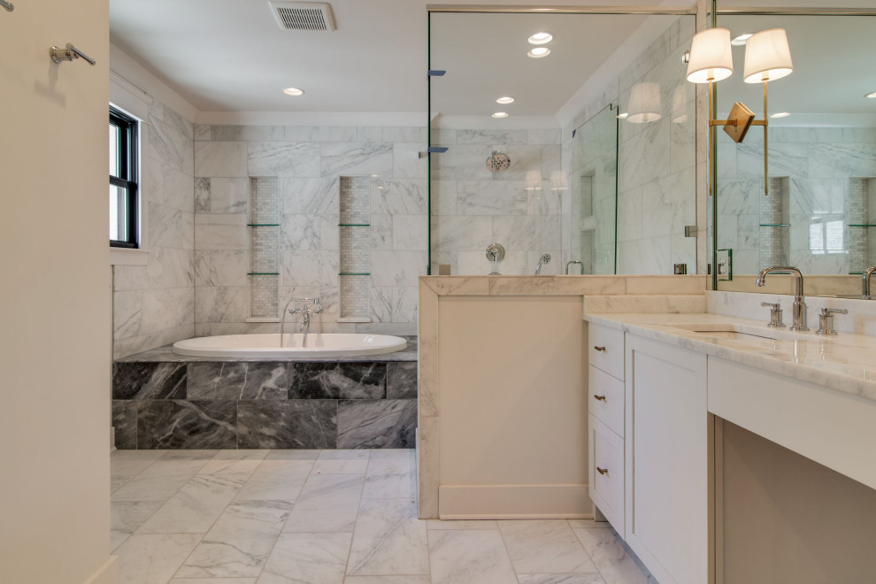 Large transitional master bathroom in Nashville with recessed-panel cabinets, white cabinets, a drop-in tub, an alcove shower, a two-piece toilet, white tile, marble, white walls, marble floors, an undermount sink, marble benchtops, a hinged shower door, white benchtops, a double vanity, a built-in vanity and an enclosed toilet.