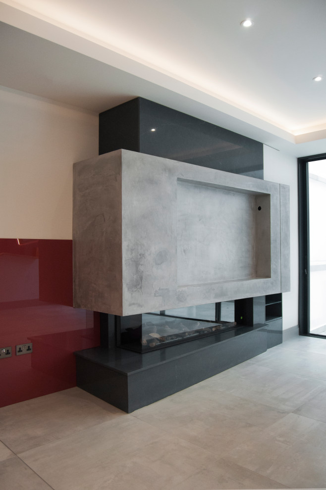 This is an example of a large modern formal open concept living room in London with white walls, ceramic floors, a corner fireplace, a concrete fireplace surround, a built-in media wall and grey floor.