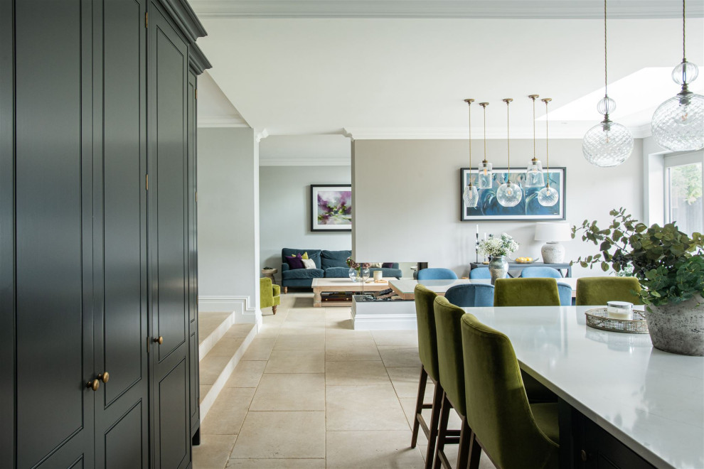 Inspiration for a large traditional open plan dining in Hertfordshire with grey walls, limestone floors, a two-sided fireplace, a plaster fireplace surround and beige floor.