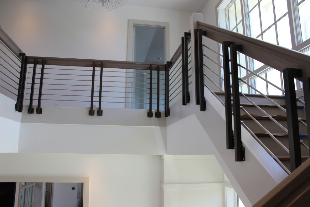 Inspiration for a large transitional wood l-shaped staircase in Other with wood risers, mixed railing and wood walls.